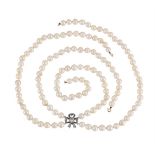A TWO ROW CULTURED PEARL NECKLACE TO A DIAMOND BOW PANEL