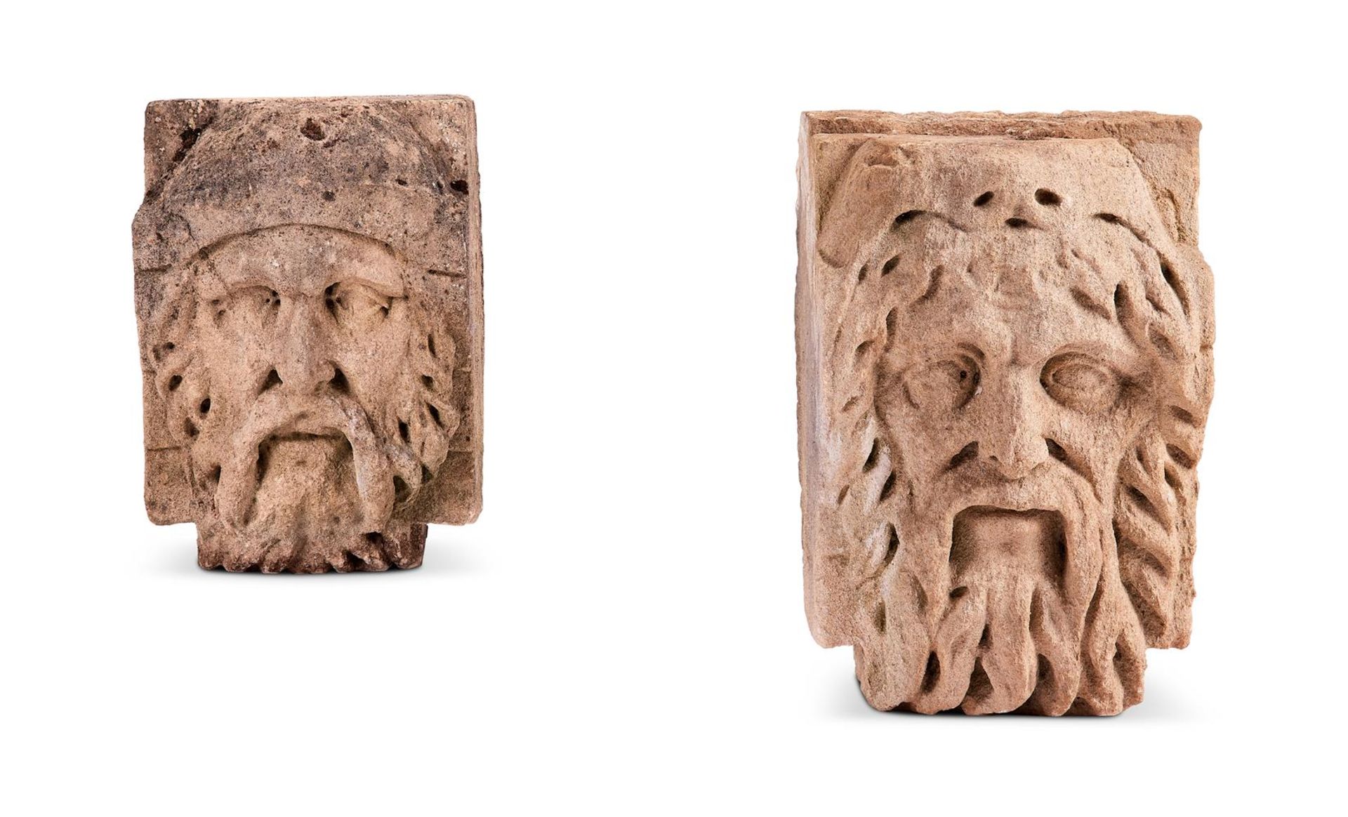 A PAIR OF CARVED COTSWOLD STONE HEADS, 18TH CENTURY