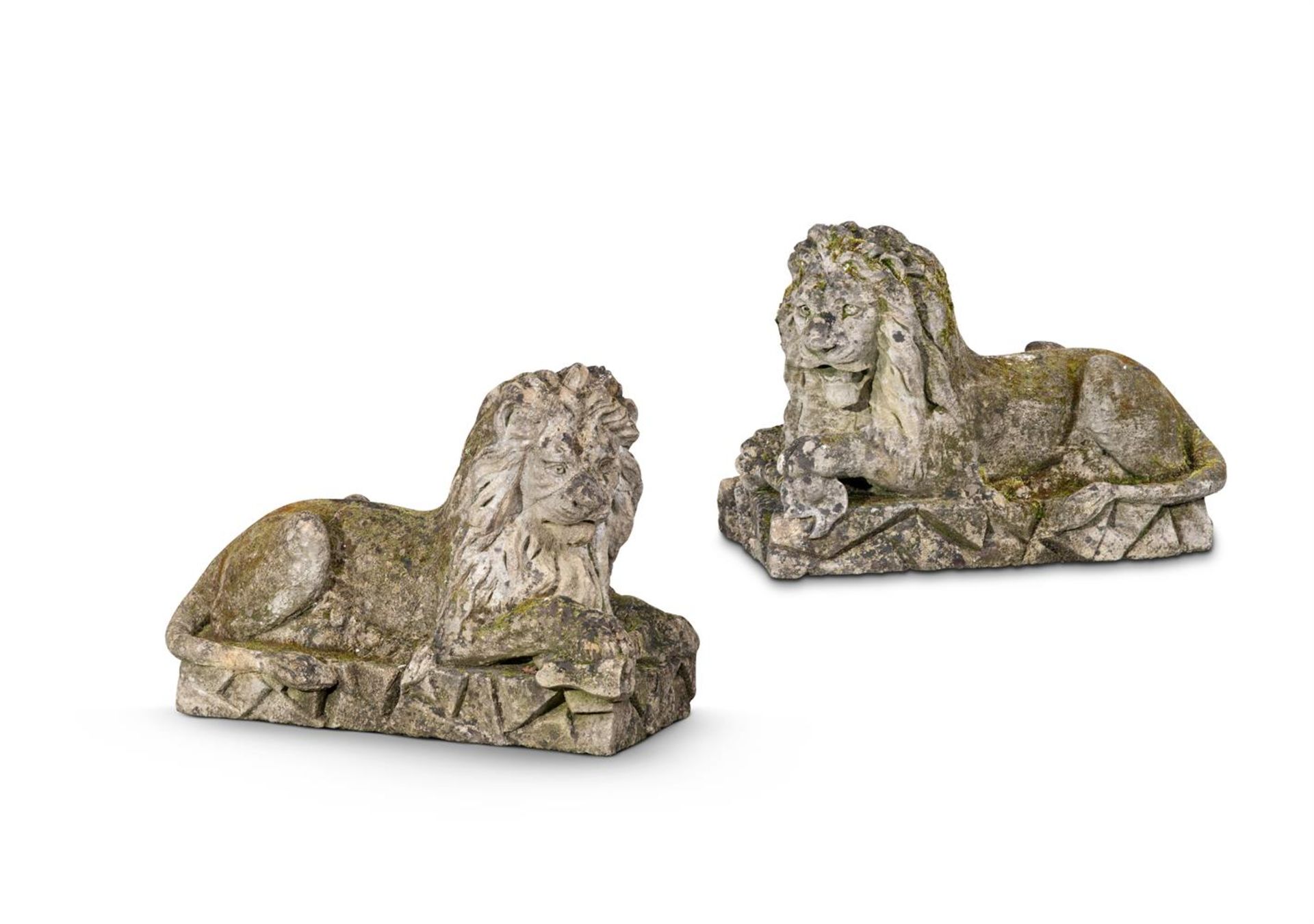 A LARGE AND IMPRESSIVE PAIR OF CARVED BATH STONE RECUMBENT LIONS, EARLY 19TH CENTURY