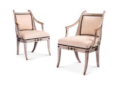 A PAIR OF SWEDISH EMPIRE CREAM PAINTED AND EBONISED OPEN ARMCHAIRS ATTRIBUTED TO EPHRAIM STAHL