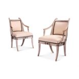 A PAIR OF SWEDISH EMPIRE CREAM PAINTED AND EBONISED OPEN ARMCHAIRS ATTRIBUTED TO EPHRAIM STAHL