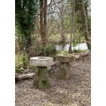 A PAIR OF HEAVY MILL WHEEL TOPPED STADDLE STONE TABLES, LATE 18TH/EARLY 19TH CENTURY