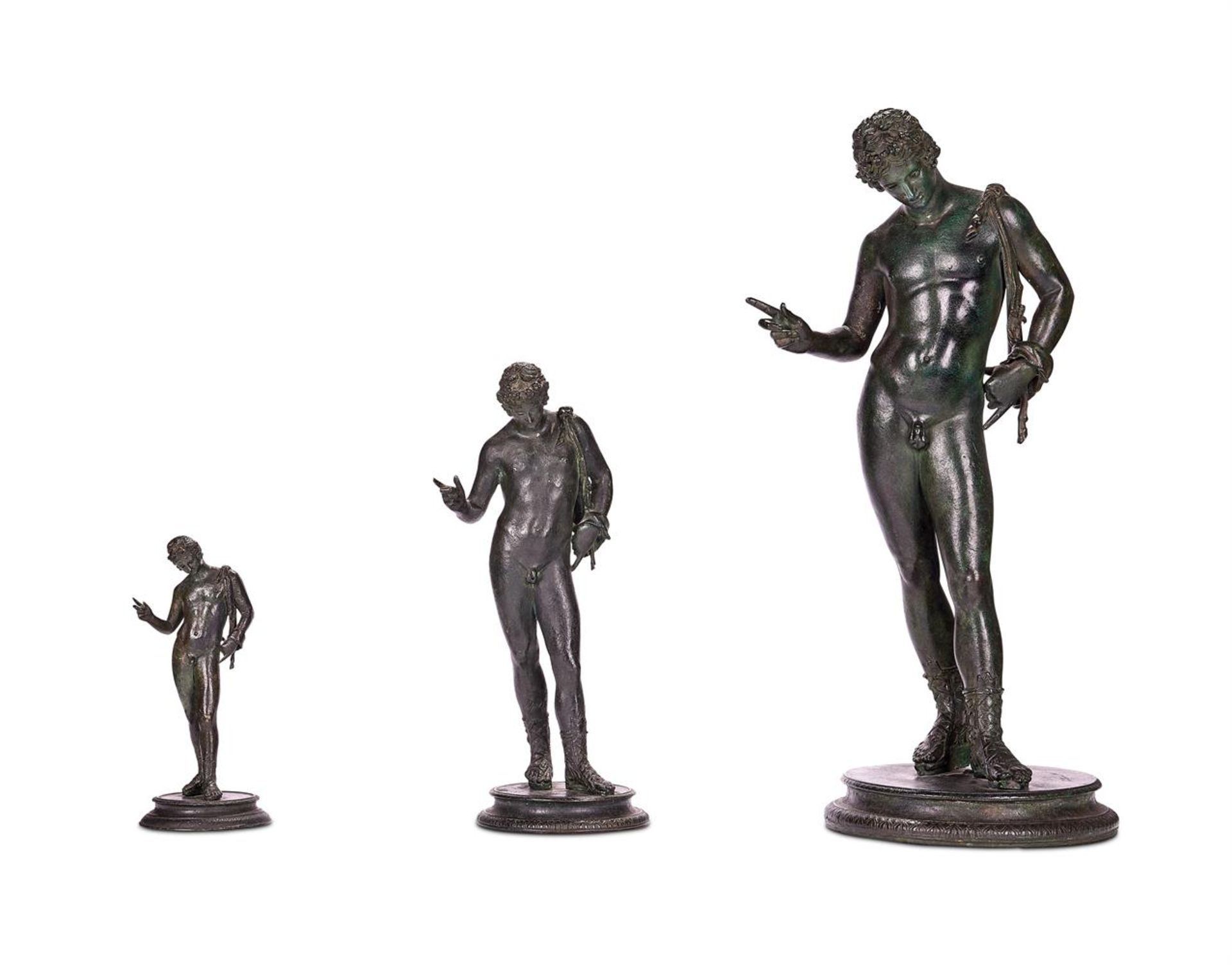 AFTER THE ANTIQUE, A GRADUATED GROUP OF THREE NEAPOLITAN BRONZE FIGURES OF NARCISSUS