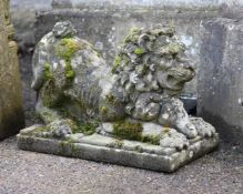 A PAIR OF STONE COMPOSITION MODELS OF RECUMBENT LIONS, 20TH CENTURY