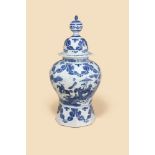 A DUTCH DELFT BLUE AND WHITE OCTAGONAL SECTION BALUSTER VASE AND COVER, CIRCA 1700