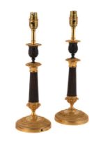 A PAIR OF GILT AND PATINATED BRONZE CANDLESTICKS