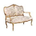 A CARVED GILTWOOD AND UPHOLSTERED CANAPE IN LOUIS XV STYLE