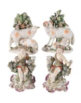 A PAIR OF DERBY BOCAGE GROUPS OF EWES AND LAMBS AND A PAIR DERBY FIGURAL CANDLESTICKS