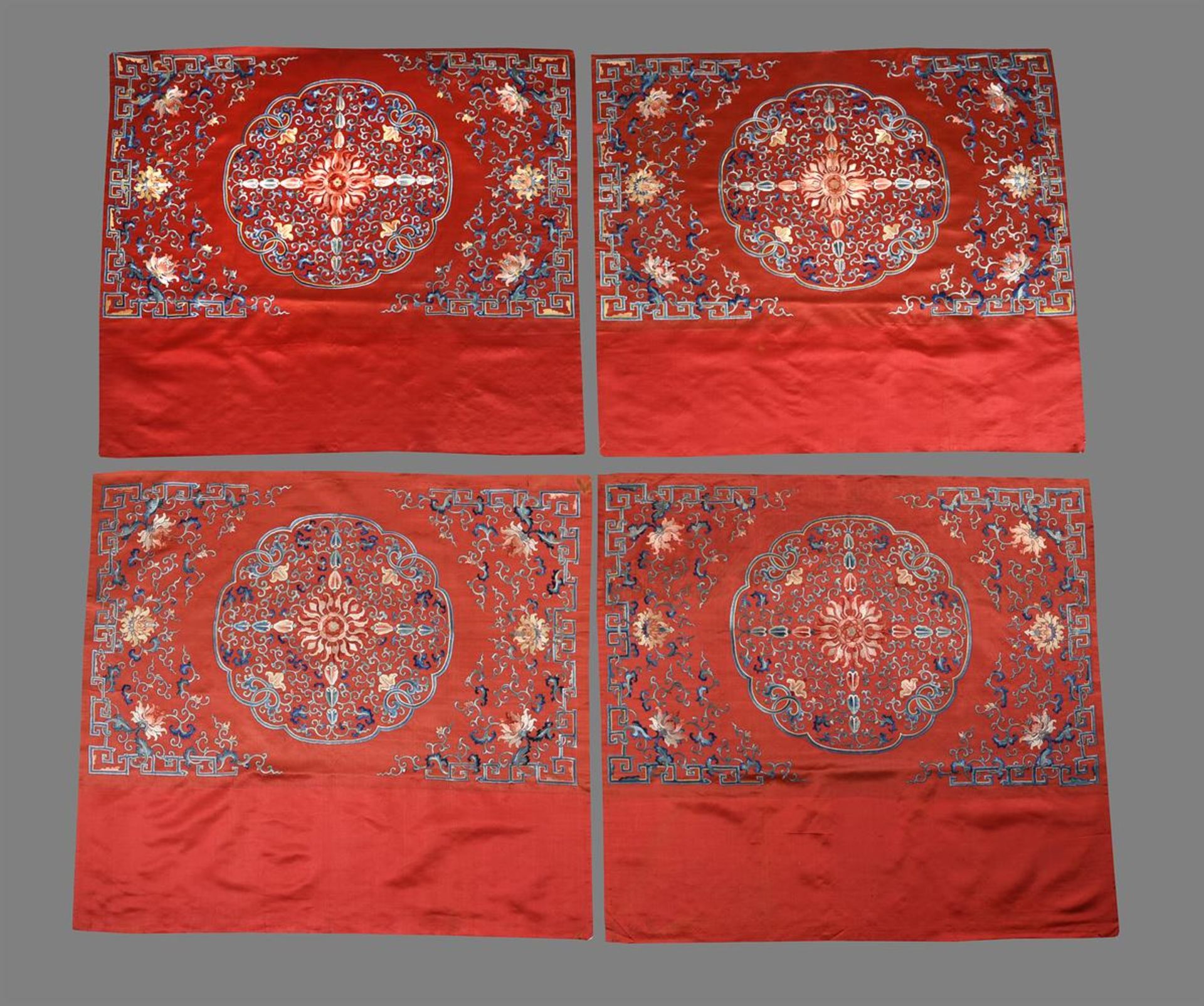 A fine set of four Chinese red silk table frontals