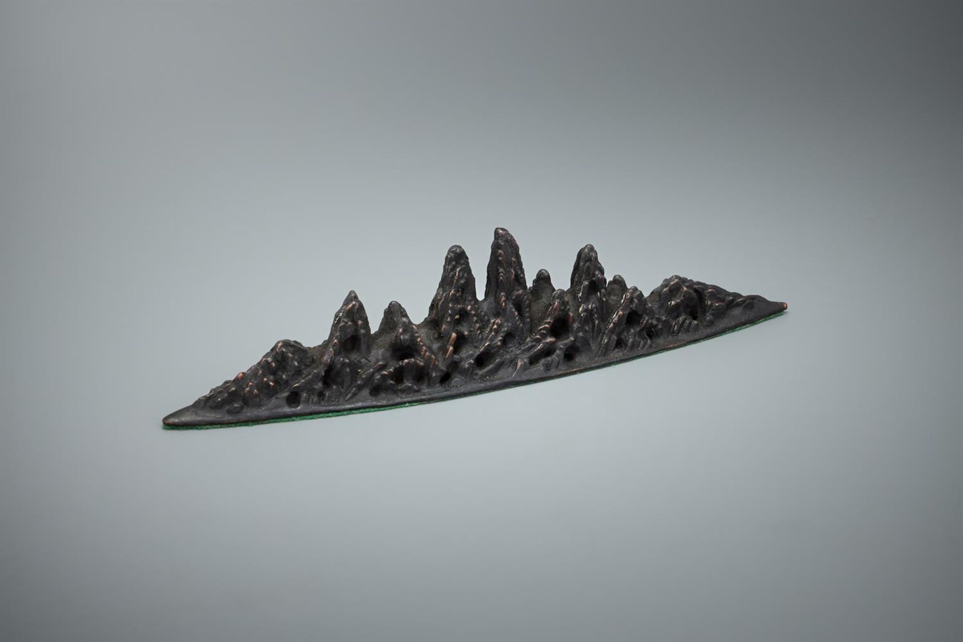 A Chinese bronze mountain-form brush rest