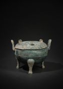 A large Chinese archaic bronze ritual food vessel and cover