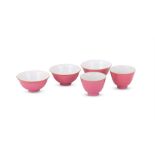 A pair of Chinese ruby-red glazed wine cups and three bowls