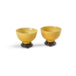 A pair of small Chinese yellow-glazed incised bowls