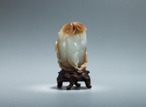 A Chinese celadon and russet jade model of a melon