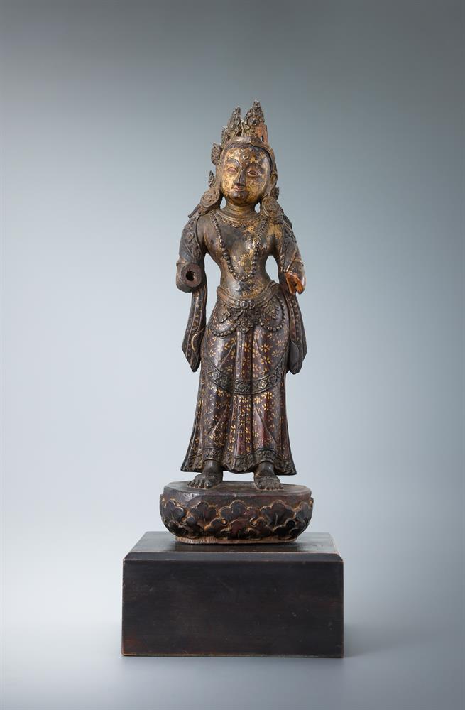 A carved wood parcel-gilt figure of a female deity - Image 2 of 3