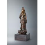 A carved wood parcel-gilt figure of a female deity