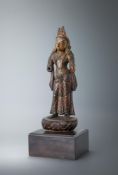 A carved wood parcel-gilt figure of a female deity