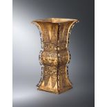 A Chinese gilt bronze Gu-shaped vase