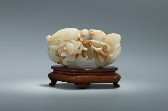 A Chinese white and russet jade model of a mandarin duck