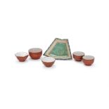 A group of Chinese Yixing tea cups and one sectioned Yixing enamelled plate