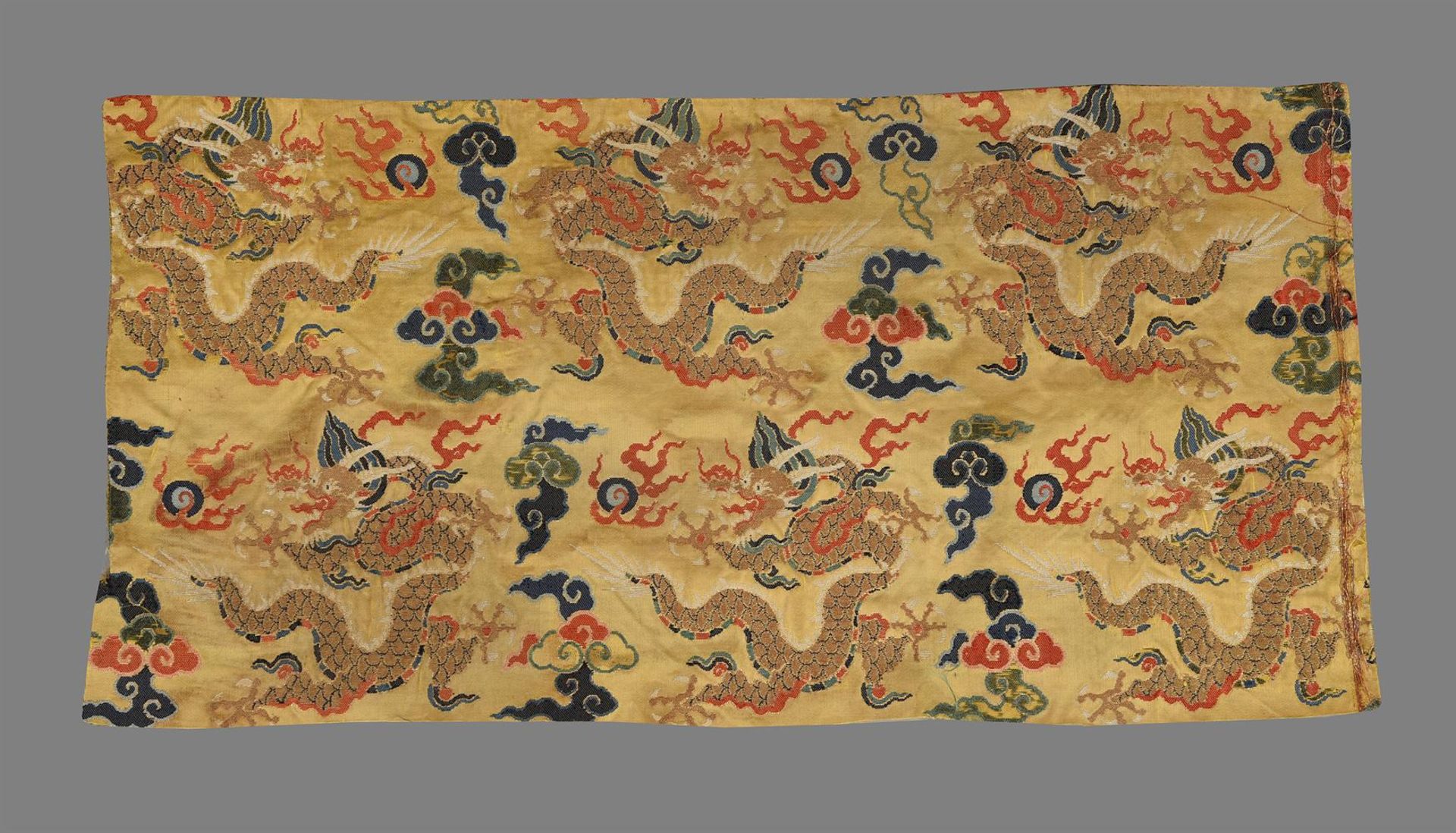 A Chinese yellow silk brocade 'Dragon' panel