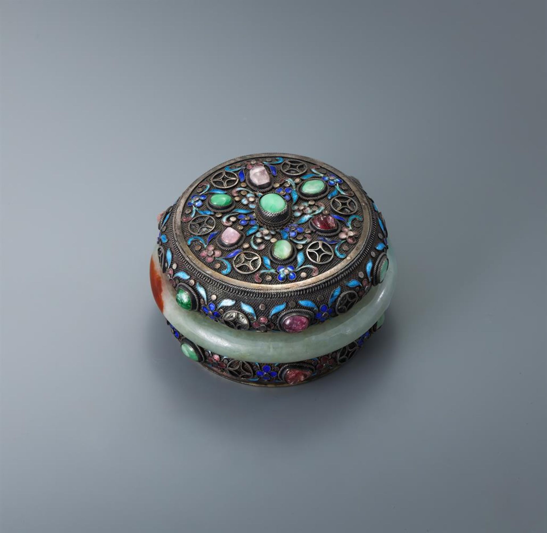 A Chinese silver jade and cloisonné gem set circular box and cover