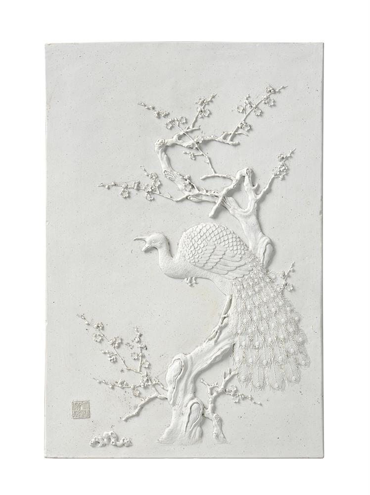 A Chinese biscuit plaque of a peacock in a prunus tree