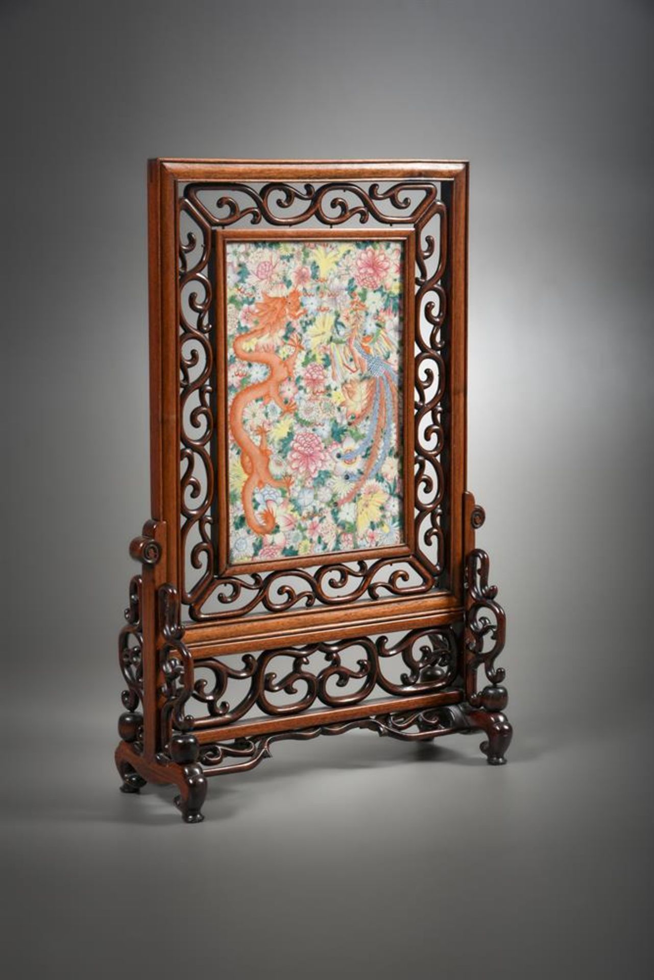 A Chinese hardwood 'Dragon and Phoenix' millefleur screen