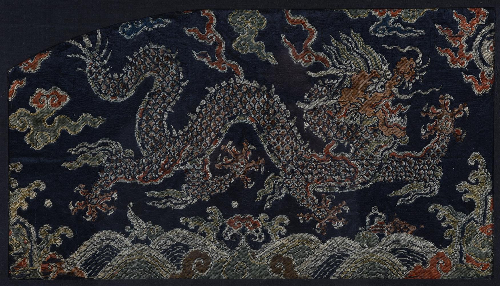 A Chinese indigo brocade panel of a running five-clawed dragon