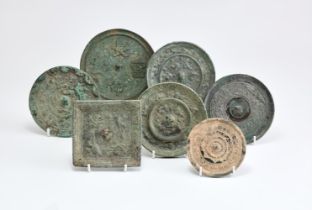 A group of seven Chinese bronze mirrors