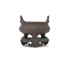 A Chinese bronze tripod censer and stand