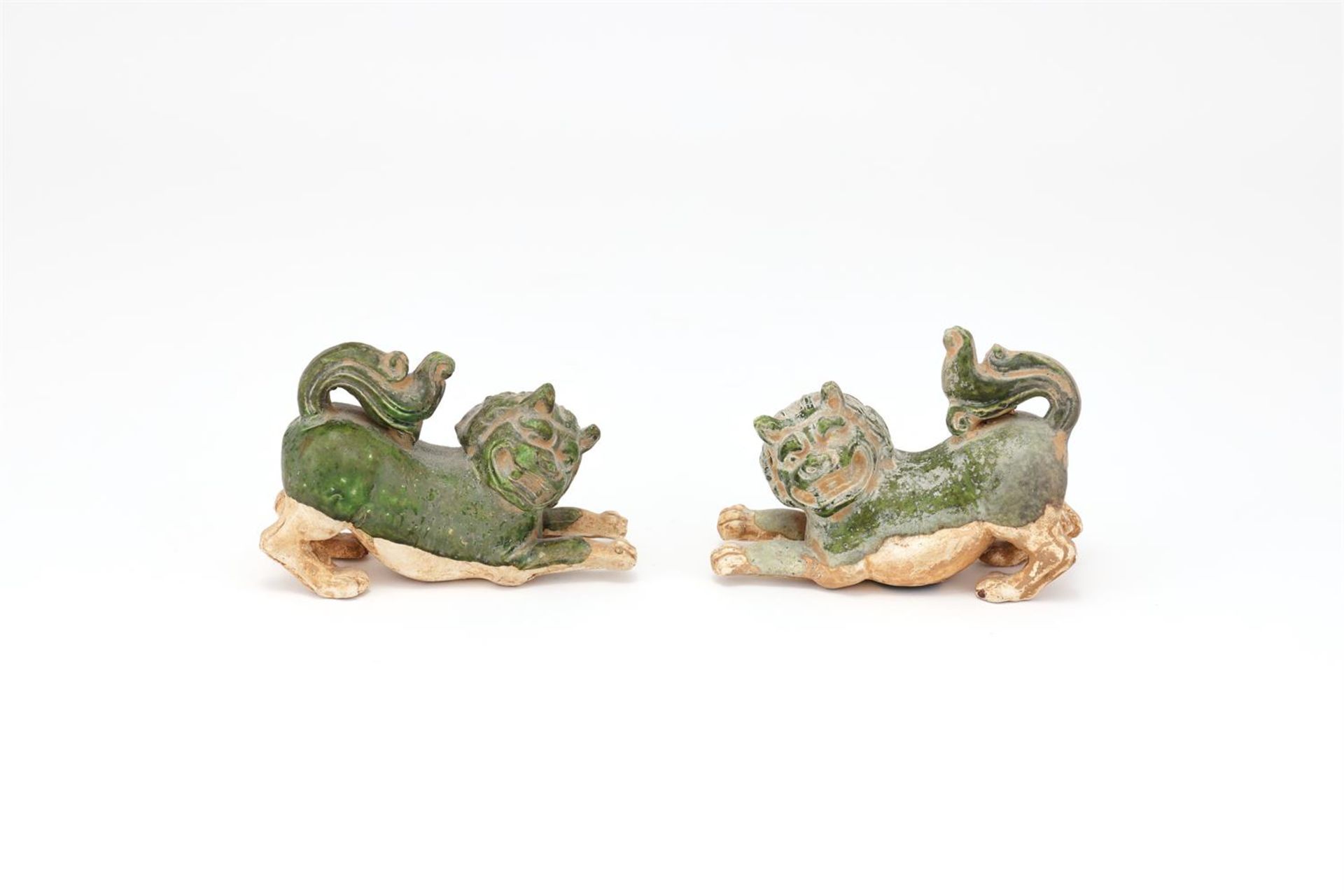 A pair of Chinese green glazed models of lions
