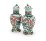 A pair of Chinese Famille Verte 'Dragon' vases and covers