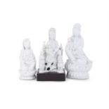 A group of three Chinese Dehua seated figures of Guanyin