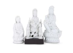 A group of three Chinese Dehua seated figures of Guanyin