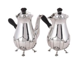 AN EDWARDIAN PAIR OF SILVER CAFE AU LAIT POTS