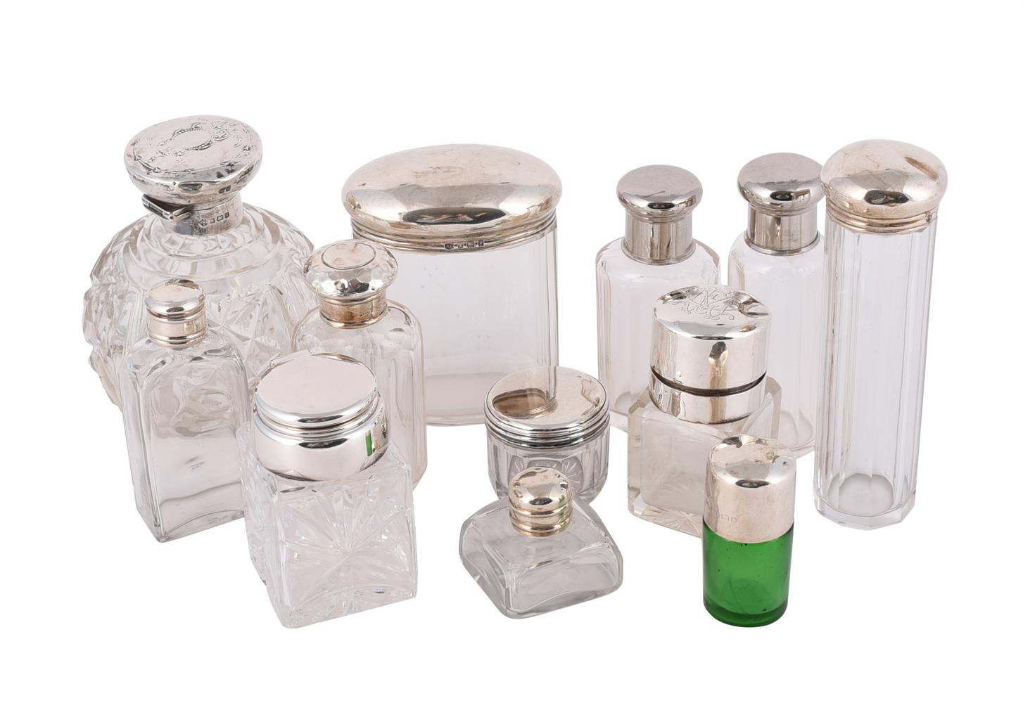 A COLLECTION OF GLASS DRESSING TABLE JARS AND BOTTLES