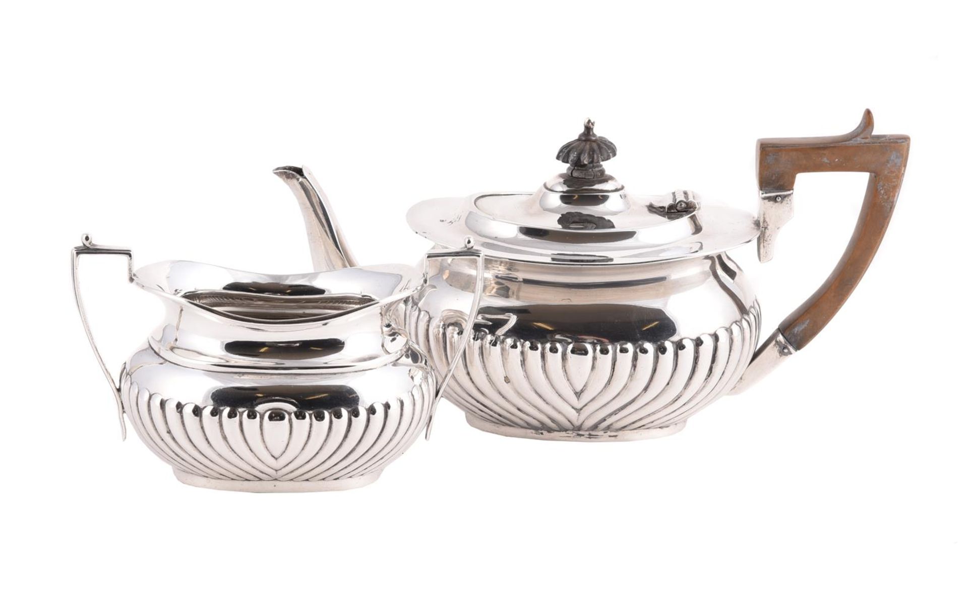 AN EDWARDIAN SILVER OBLONG BALUSTER TEA POT AND SUGAR BOWL