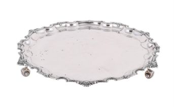 A SILVER SHAPED CIRCULAR SALVER