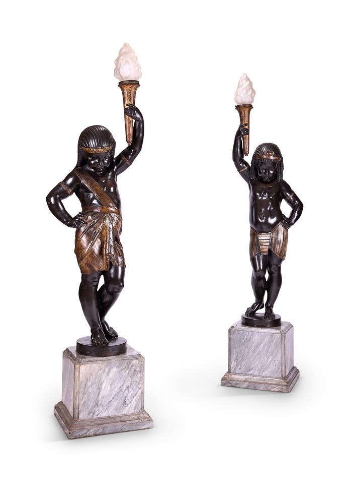 A PAIR OF PARCEL GILT AND PATINATED CAST IRON FIGURAL TORCHÈRES IN THE EGYPTIAN REVIVAL STYLE CAST