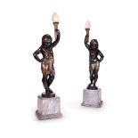 A PAIR OF PARCEL GILT AND PATINATED CAST IRON FIGURAL TORCHÈRES IN THE EGYPTIAN REVIVAL STYLE CAST