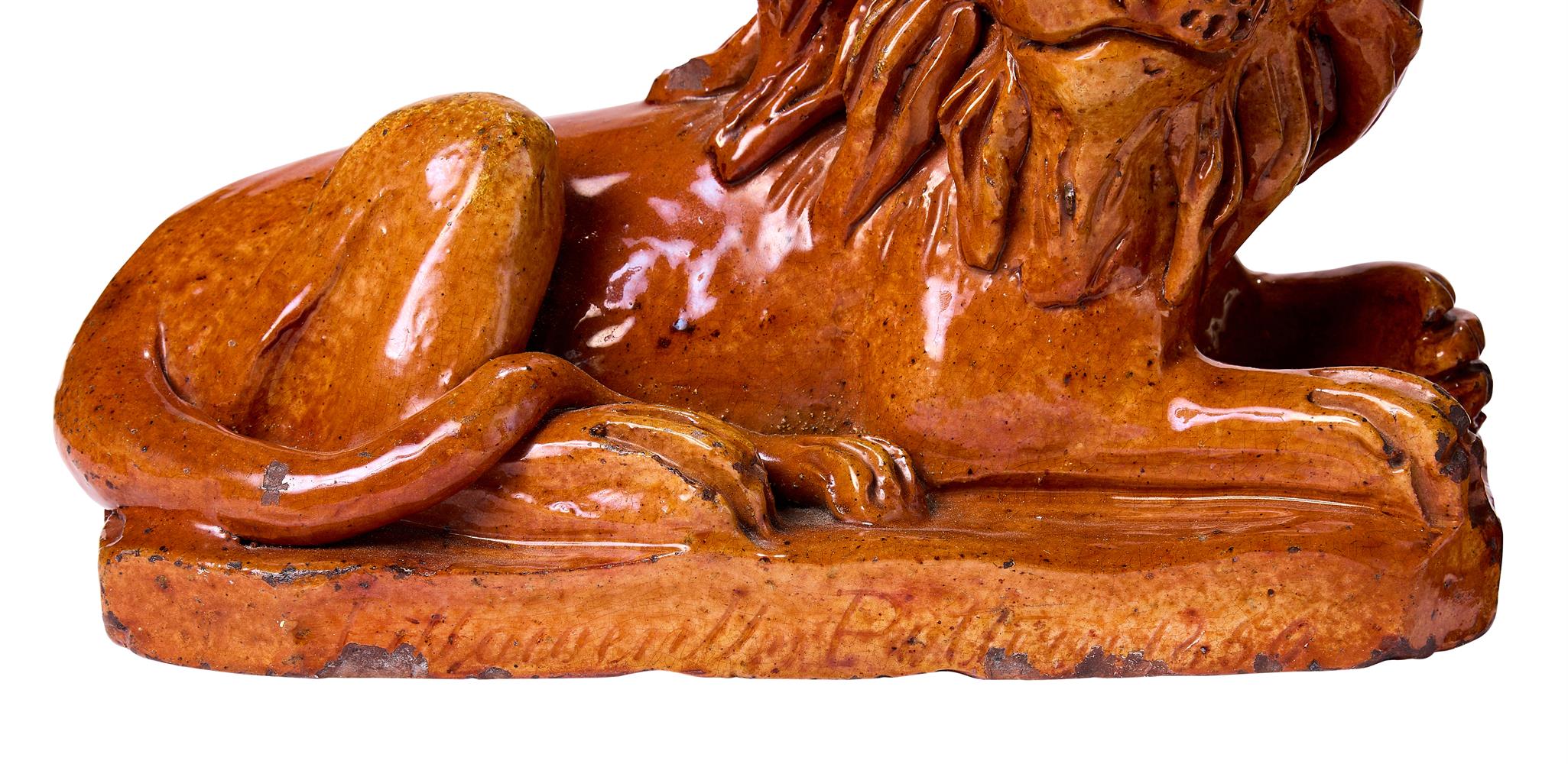 A PAIR OF PILL POTTERY (NEWPORT MONMOUTHSHIRE) TREACLE-GLAZED RED POTTERY MODELS OF RECUMBENT LIONS - Image 3 of 3