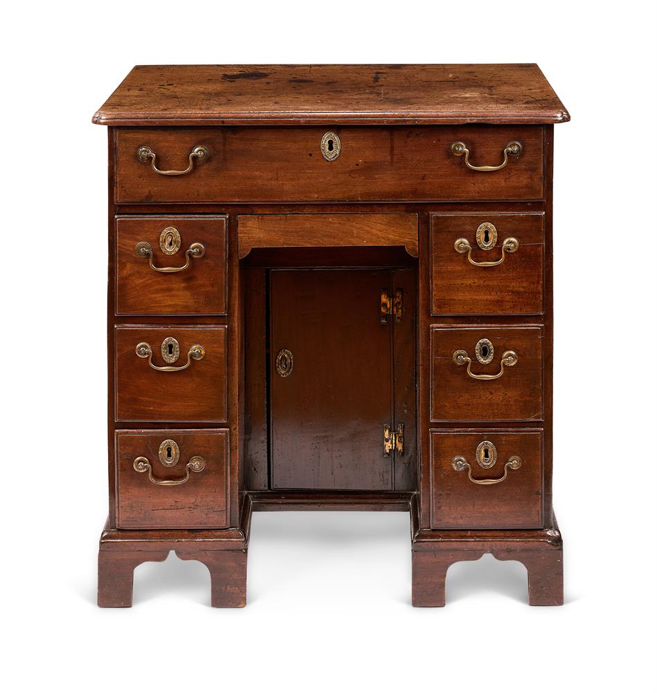 A GEORGE II MAHOGANY KNEEHOLE DESK OR DRESSING-TABLE CIRCA 1750