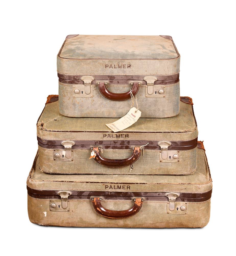 A SET OF THREE LINEN SUITCASES 20TH CENTURY