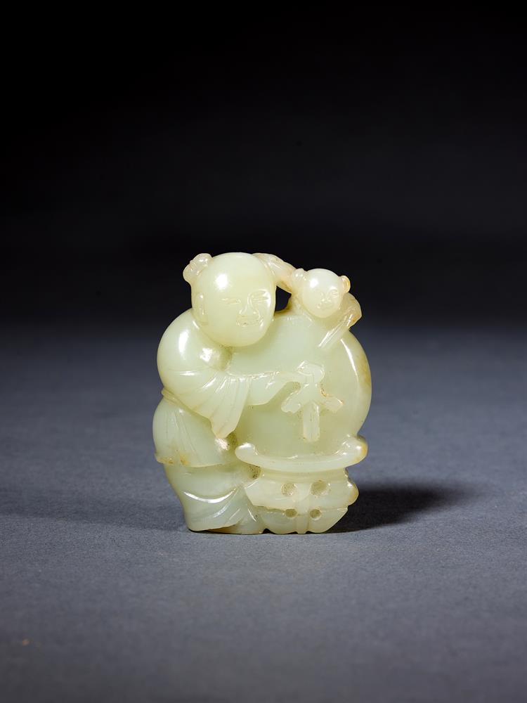 A CHINESE PALE CELADON JADE CARVING OF A 'BOY AND DRUM', QING DYNASTY