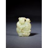 A CHINESE PALE CELADON JADE CARVING OF A 'BOY AND DRUM', QING DYNASTY