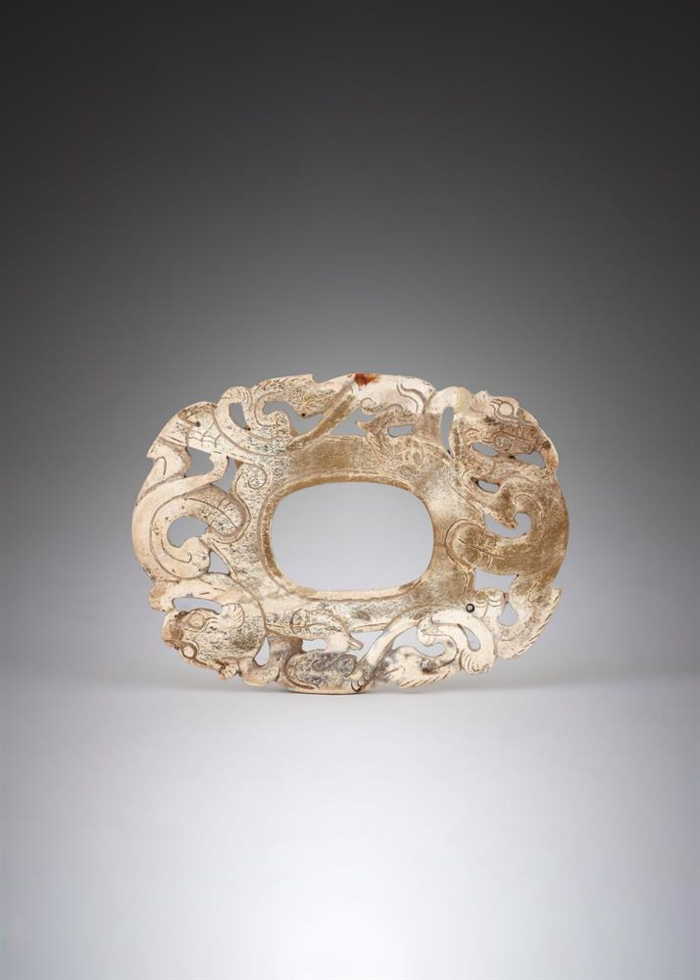 A CHINESE CALICIFIED 'CHICKEN BONE' JADE PLAQUE, WARRING STATES-HAN PERIOD (475 BC-220 AD)