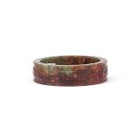 A CHINESE CELADON AND RUSSET JADE BANGLE, MING DYNASTY