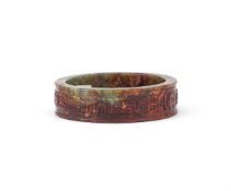A CHINESE CELADON AND RUSSET JADE BANGLE, MING DYNASTY