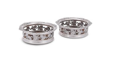 A PAIR OF GEORGE III SILVER MOUNTED SHAPED CIRCULAR COASTERS